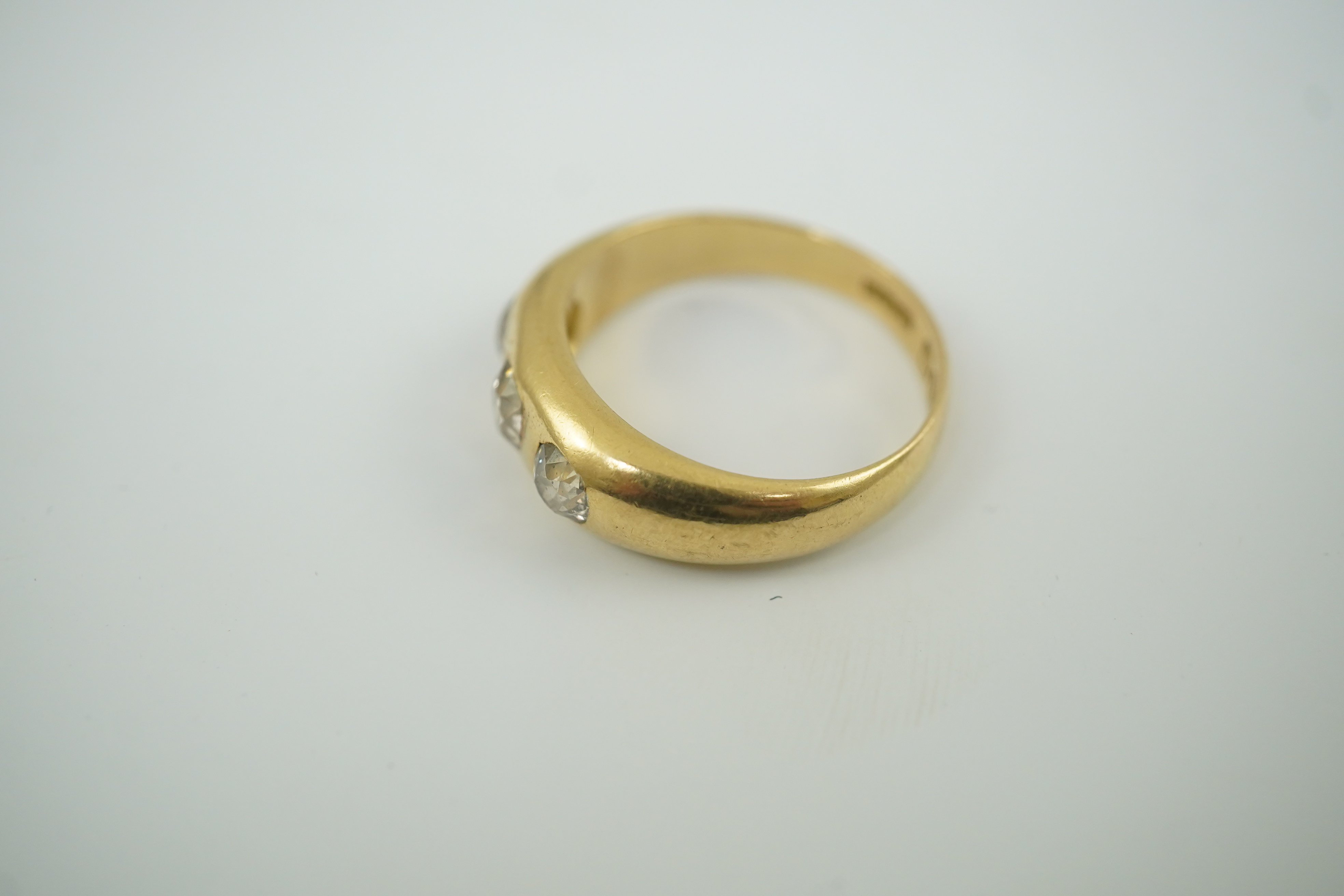 An Edwardian 18ct gold and gypsy set three stone diamond ring